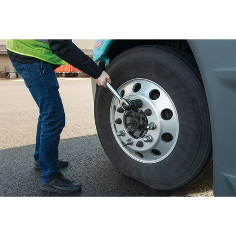 Person using Beefy Heavy Duty 40 Inch Breaker Bar With 180 Degree Swivel Head For 1 Inch Drive Chrome Vanadium Steel on truck tire