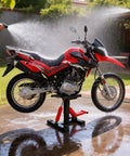 Dirt bike on Beefy 1000 Lbs Hydraulic Dirt Bike Lift Stand with Removable Tool Tray, being washed with water spray