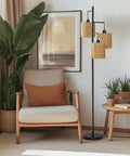 65 Inch Boho Rattan Floor Lamp With Three Lights next to a chair, featuring rattan shades, in a cozy living room setting.