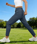 Side view of woman wearing Lightweight Breathable Hiking Pants For Women Over 50 With Zipper Pockets Stretch Active Quick Dry Travel Pants For Camping Fishing And Workouts Comfortable Fit Navy Blue