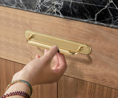 Hand installing 2 Pack Champagne Bronze Cabinet Pulls With Backplates, 7 1/2 Inch Center-to-Center Drawer Handles on wooden cabinet