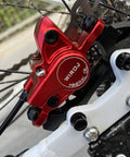 Sick Stopping Power Hydraulic Disc Brake Set For Mountain Bikes includes red caliper with mineral oil labeling and black rotor.