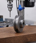 Cast Iron V Belt Pulley Wheel 100Mm Od With 19Mm Bore And 6mm Keyway for air compressor motor shaft on wooden surface.