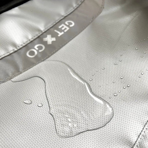Close-up of 20L silver grey water-resistant fabric on Fireproof Bug Out Backpack For Docs And Tech, showing water droplets