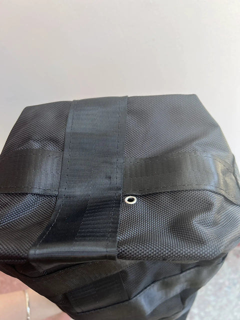 Bottom view of Beefed Up Heavy Duty Chain Container Bag For 2 Ton Manual Hoist, showing durable nylon fiber and water drain hole.