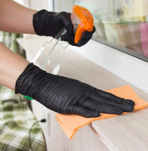 Person wearing Nitrile Disposable Gloves Extra Large Black Powder Free Industrial Grade Latex Free in cleaning activity