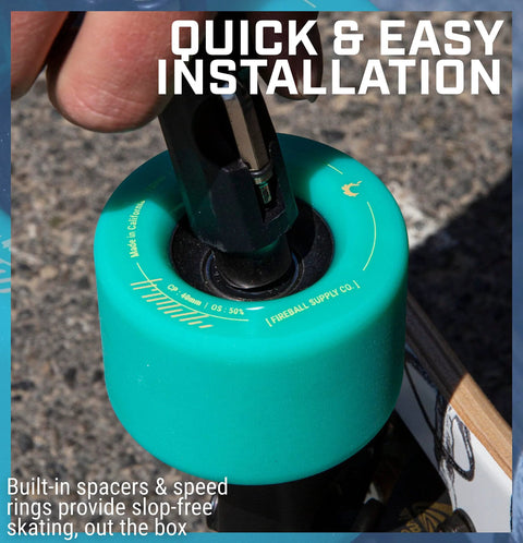 Teal Fireball skateboard wheel being installed with built-in spacers and a bearing press tool.
