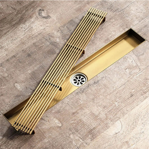 Heavy Duty Rectangular Shower Floor Drain In Sleek Brushed Gold Finish Made From Tough Stainless Steel With Removable Hair Catcher Grate For Quick Dry Performance And Zero Drama In Your Modern Setup.