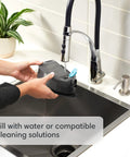 Filling Roomba Combo I5 Plus self-emptying robot vacuum and mop water tank at sink