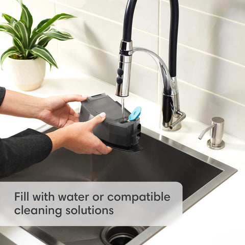 Filling Roomba Combo I5 Plus self-emptying robot vacuum and mop water tank at sink