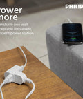 Phone charging on table using Philips white power adapter with multiple outlets and cords.