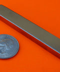2 Pack Nickel-Coated Bar Magnets, 3 By One Eighth By Five Sixteenth Inch Rectangular Neodymium Mounting Magnets next to a coin