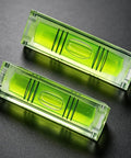 2 Pack Magnetic Mini Bubble Level Tool 2 Inch, Small Pocket in green with measurement lines on a dark background.