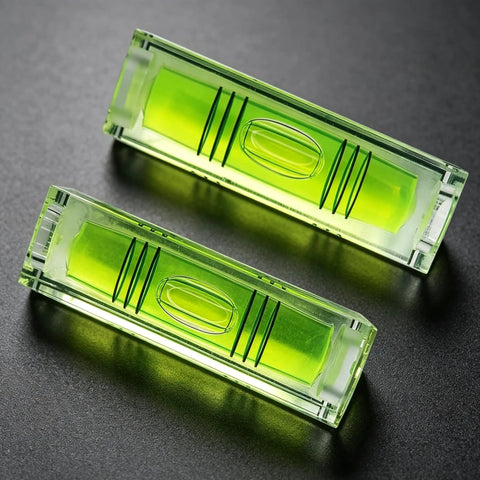 2 Pack Magnetic Mini Bubble Level Tool 2 Inch, Small Pocket in green with measurement lines on a dark background.