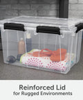 54 Quart Tough As Nails Crystal Clear Storage Tote With IP68 Rated Gasket Sealed Lid And Heavy Duty Secure Latches full of items on a workspace.