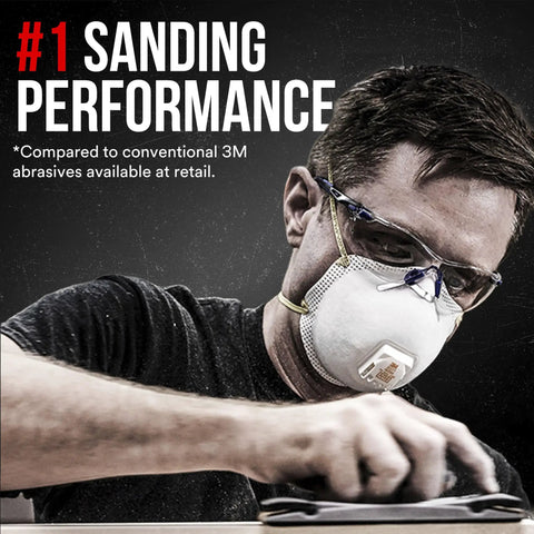 Pro Grade Purple Sandpaper 180 Grit No-Slip Grip For Wet Or Dry Use With Premium Cubitron II Mineral Grits Durable Backing To Reduce Hand Fatigue And Prevent Tearing In This Huge 100 Pack Of 9x11 Sheets Perfect For Any Home Pro Project, a man sanding wood wearing protective gear.