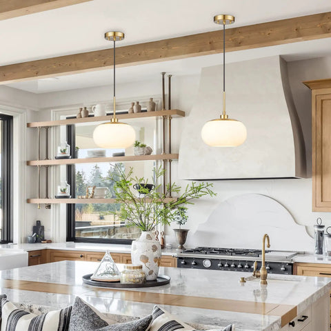 Single Opal Glass Pendant Light With Antique Brass Finish for a Cozy Modern Vibe, Warm Diffused Glow in a kitchen setting.