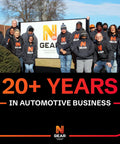 Team standing in front of Nth Gear sign, celebrating 20+ years in automotive business.