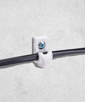 White Wire Shelf Brackets With Mounting Hardware Heavy Duty Closet Clips Built Tough For Pantry And Garage Storage installed on a wall.