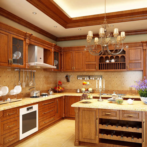 Elegant kitchen showcasing wooden cabinets with vintage oval brass knobs, chandelier, marble countertops, and built-in appliances.