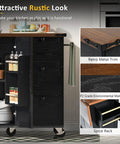 54 Inch Farmhouse Kitchen Cart Featuring A Nifty Power Outlet And Hefty Storage Space With Smooth Rolling Lockable Wheels And Sleek Black Finish in kitchen setting.