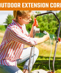 Woman using Heavy Duty Extension Cord 16/3 20 Feet Indoor Outdoor Single Outlet UL Listed White Power Cable with tool