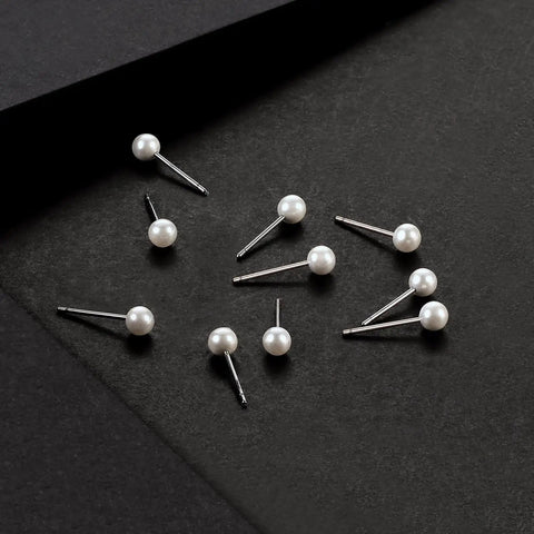 Imitation Pearl Stud Earrings Set For Women, 12 Pairs Of 4mm Round Ball Pearls, Hypoallergenic Surgical Stainless Steel, Lead And Nickel Free, Everyday Sparkle Go To Jewelry For Work Casual Gifting, laid out on black background