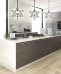 Kitchen scene with three 12-Inch Oil Rubbed Bronze Moravian Star LED Pendant Lights With Clear Glass illuminating modern island setup.