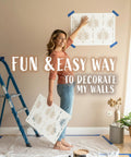 Woman using Fern Wall Stencil Set 2 Pack 17 By 22.5 Inches For Painting Large Patterns Perfect DIY Wallpaper Alternative on a wall.