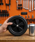 Hand holding a Heavy Duty 7 Inch Solid Tire For Generator And Welder Flat Free Rubber Wheel With Anti Slip Grip.