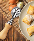 Front view of pasta cutter wheel with wooden handle and 1.3-inch steel wheel for cutting ravioli/pizza dough.