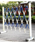 No Sweat Setup Heavy Duty Expandable Metal Barrier With Smooth Roll Wheels, Retractable Mobile Safety Gate, Tough Crowd Control Fence For Garage Jobs And Site Zone Lockdown in white and blue colors, expandable to 2.5 meters.