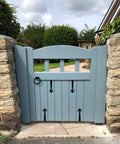 Wooden gate with Rustic Matte Black 8 Inch Decorative Barn Door Bracket I Shape Dummy Gate Hinge visible in garden setting.