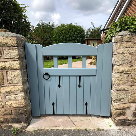 Wooden gate with Rustic Matte Black 8 Inch Decorative Barn Door Bracket I Shape Dummy Gate Hinge visible in garden setting.
