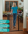 Woman installing Tall And Wide Auto Close Baby Gate With Magnetic Lock Technology, Pressure Mounted for Quick Easy Peasy Install
