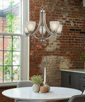Farmhouse 24 Inch Five Light Chandelier With Clear Glass Shades, Adjustable Chain, Smoked Birch Finish in dining room setting