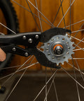 Vise Whip II Cassette Removal Tool For Bikes shown gripping a sprocket on a bicycle wheel, heat treated steel, easy release jaws.