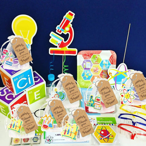 Science Party Favors 12 Pack Keychains With Thank You Kraft Tags And Organza Bags displayed with colorful science decorations