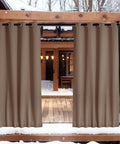Two Panels Weighted Blackout Outdoor Curtains For Patio And Pergola Waterproof And Thermal Insulated With Top And Bottom Grommets And Back Tab Wind Resistant Privacy Drapes In Tan Khaki 52 By 84 Inches hanging between wooden posts on snowy patio