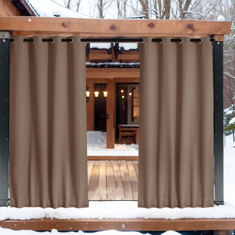 Two Panels Weighted Blackout Outdoor Curtains For Patio And Pergola Waterproof And Thermal Insulated With Top And Bottom Grommets And Back Tab Wind Resistant Privacy Drapes In Tan Khaki 52 By 84 Inches hanging between wooden posts on snowy patio