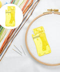 Twelve Piece Automatic Needle Threaders For Hand Sewing And Embroidery With Portable Design And Universal Fit Yellow Threading Tool on fabric