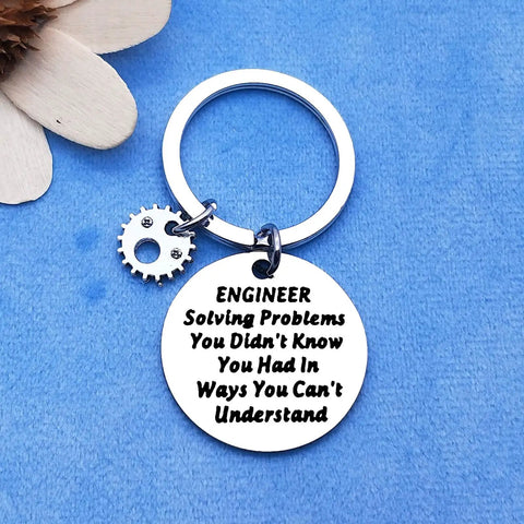 Engineer Solving Problems You Didnt Know You Had Keychain with pendant, gear charm on blue background.