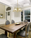 Millbridge Traditional 5-Light Indoor Dimmable Chandelier With Clear Ribbed Glass Shades For Entryway Foyer And Dining Room In Polished Brass illuminating a dining area