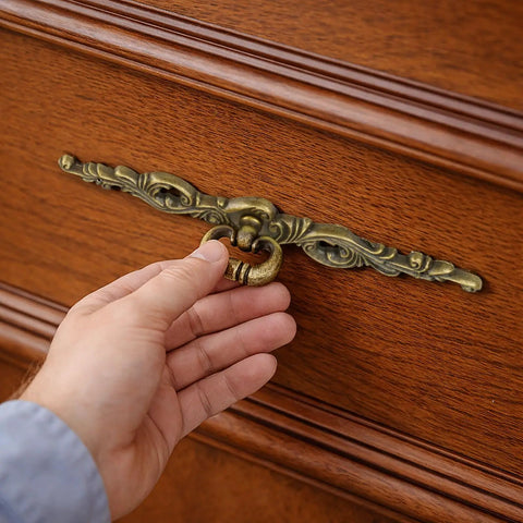 Hand holding Vintage Bronze Long Drawer Pulls Old School 4 Pack With Screws 200mm Length on wooden dresser