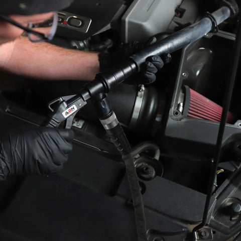 Slick Radiator Flush Kit Gun With Garden Hose Quick Connect being used on automotive engine for coolant flushing.