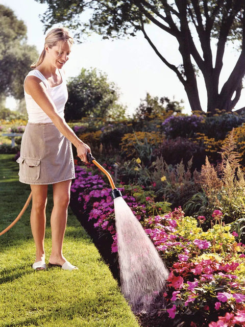 Touch-N-Flow Rain Wand 16 Inch Length Green with One-Touch Lever for Gentle Full-Flow Watering in use on flower garden