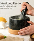 Heavy Duty Granite Mortar And Pestle Set 2 Cup Stone Grinder For Spices And Herbs With Non Slip Wooden Base shown on countertop