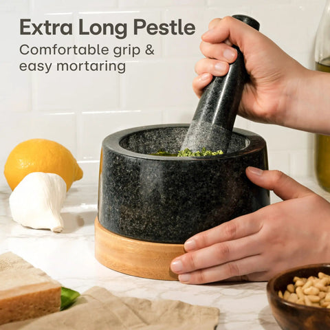Heavy Duty Granite Mortar And Pestle Set 2 Cup Stone Grinder For Spices And Herbs With Non Slip Wooden Base shown on countertop