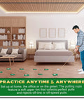 Man using 9 Pack Golf Putting Cups With Flags Indoor Outdoor Practice Set in bedroom on wooden floor, showing ease of use indoors.