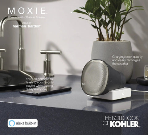 Moxie Alexa Enabled Showerhead With Dope Bluetooth Speaker and Radio next to sink, charging on dock, polished chrome finish